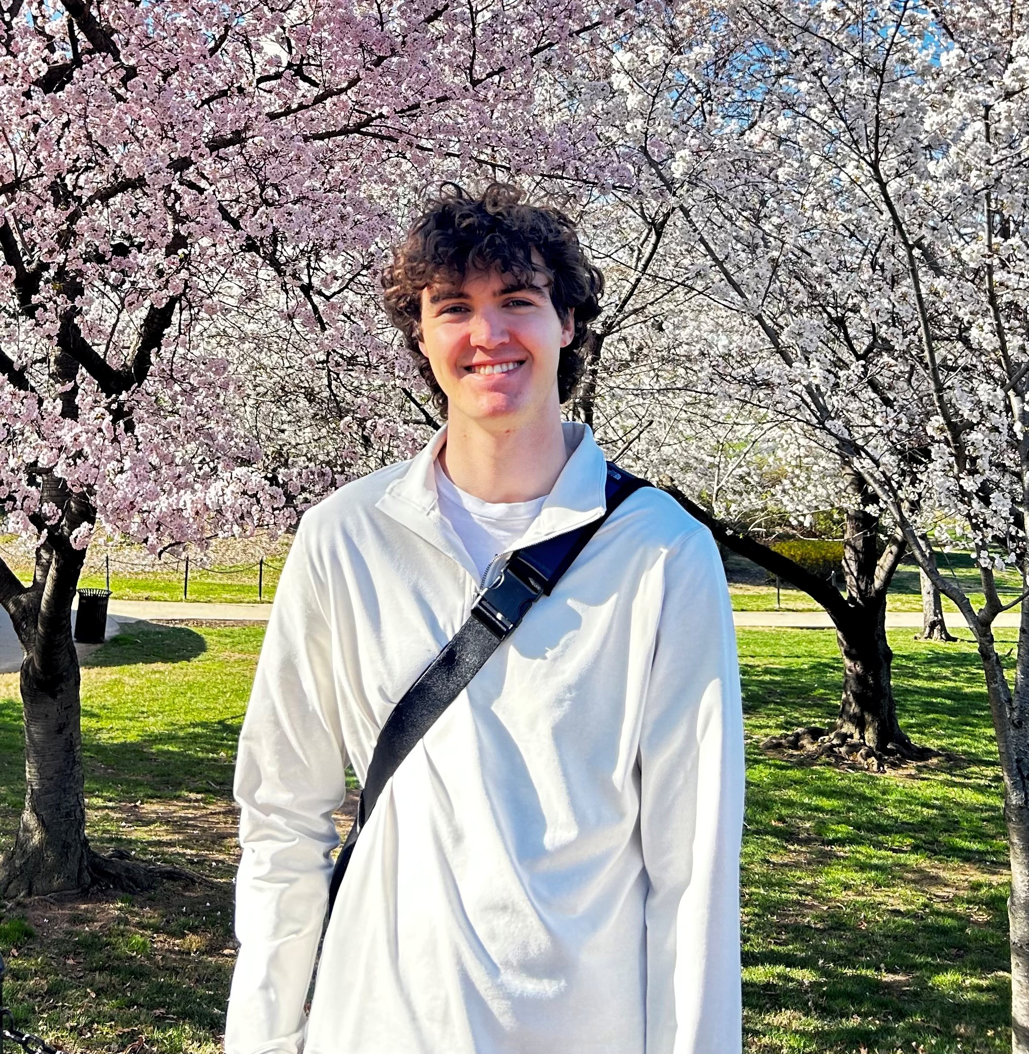 colton kelley first year t32 trainee in front of cherry trees