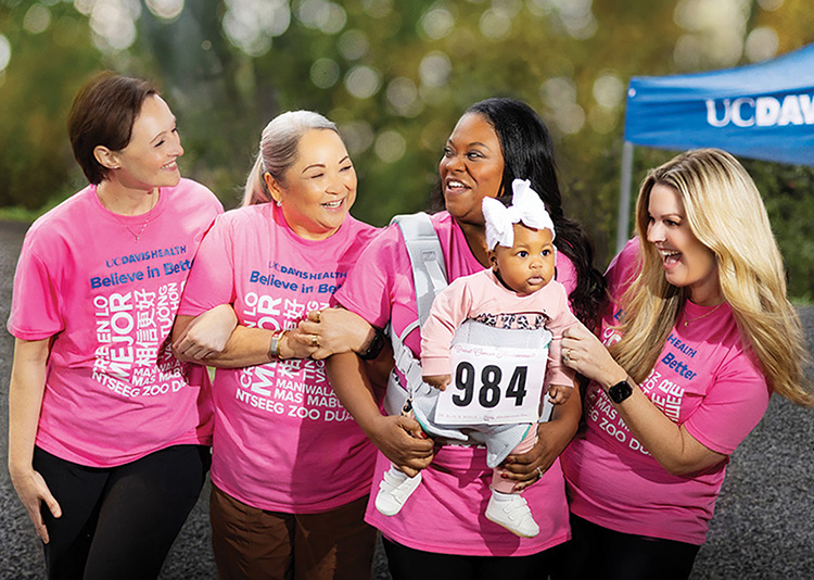 four women and a baby volunteering at a community event