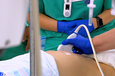 A doctor using an ultrasound machine on a patient.