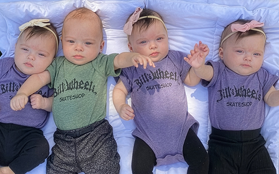 Pediatric quadruplets laying on a blanket
