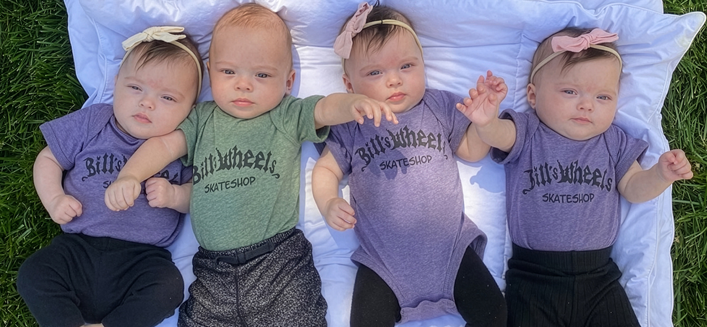 Pediatric quadruplets laying on a blanket