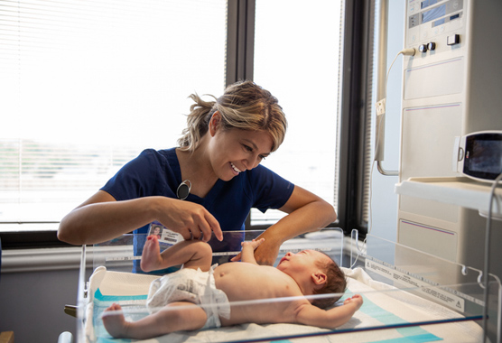 Nurse taking care of baby with anorectal malformation.