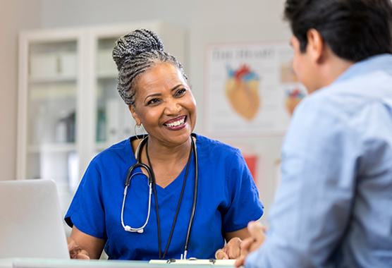 Urologist talking to patient about urinary incontentinence.
