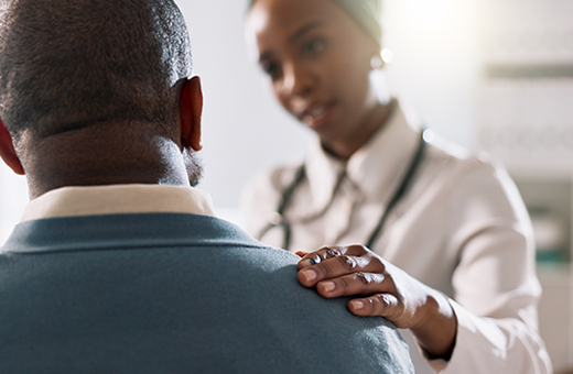 A female doctor supports a male patient. 