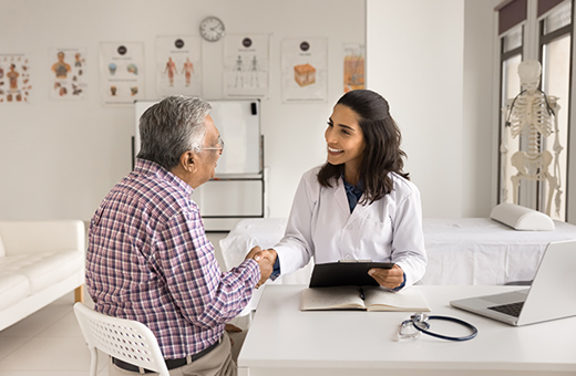 Man shaking hands with health care provider as they go over what to expect for hip replacement.