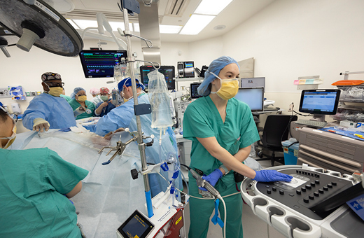 Anesthesiologist checking child’s status during pediatric neurosurgery.