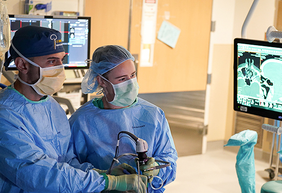 Surgeons performing pituitary tumor surgery on patient.