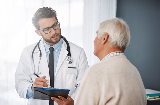 Male patient and urologist discuss prostatectomy.