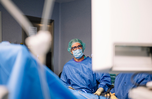 Surgeon looks at a screen in the operating room.