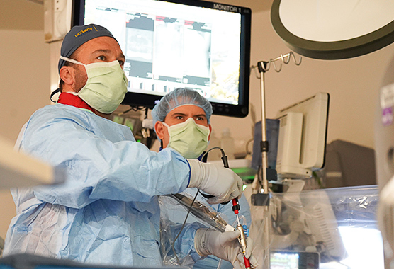 Spine surgeon discussing spine images with patient ahead of spine neurosurgery.