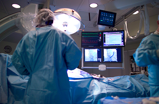 Urostomy surgeons perform surgery on a patient in the operating room.