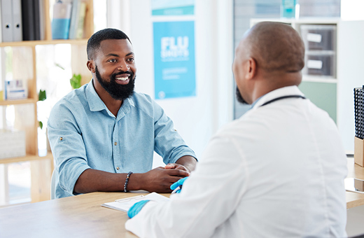 A patient smiles at a doctor after surgery.