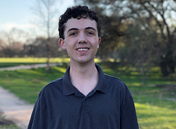 Casey Dyke stands outside, smiling toward the camera.