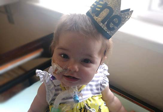 Everly wearing a hat with one on it