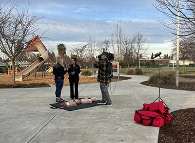 People gathered around learning CPR