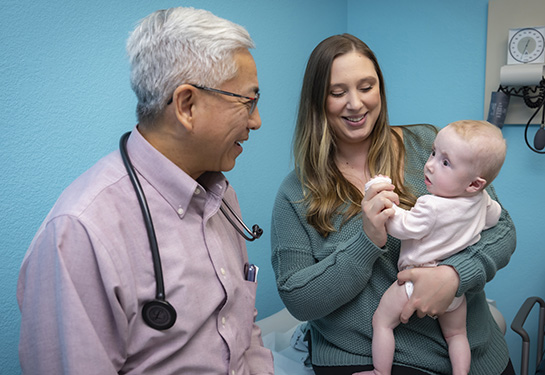 Amanda holds baby Lilian with Frank Ing