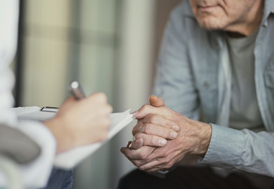 Doctor talks with patient and takes notes