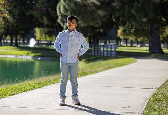 Child stands in park. 