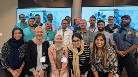 Employees smiling for a group photo at a community event