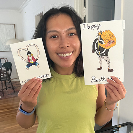 Nhu Y “Thi” Doan shows two handmade greeting cards, reflecting a longtime hobby of creating personalized cards