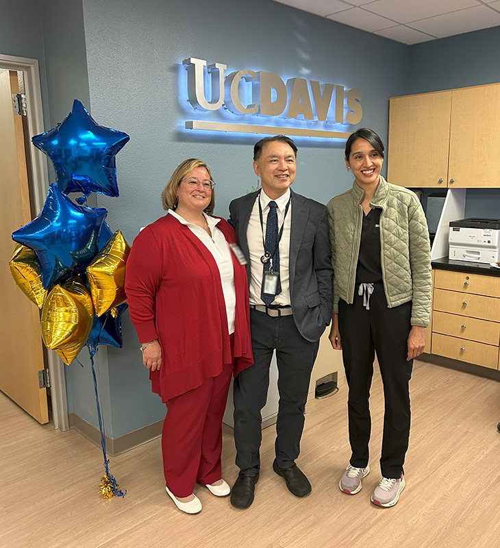Three care team members near medical clinic reception desk