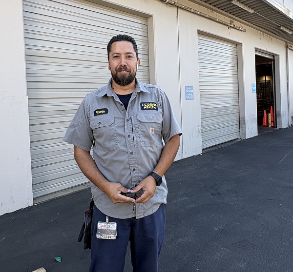 Employee stands outside the warehouse near loading doors and receiving areas.