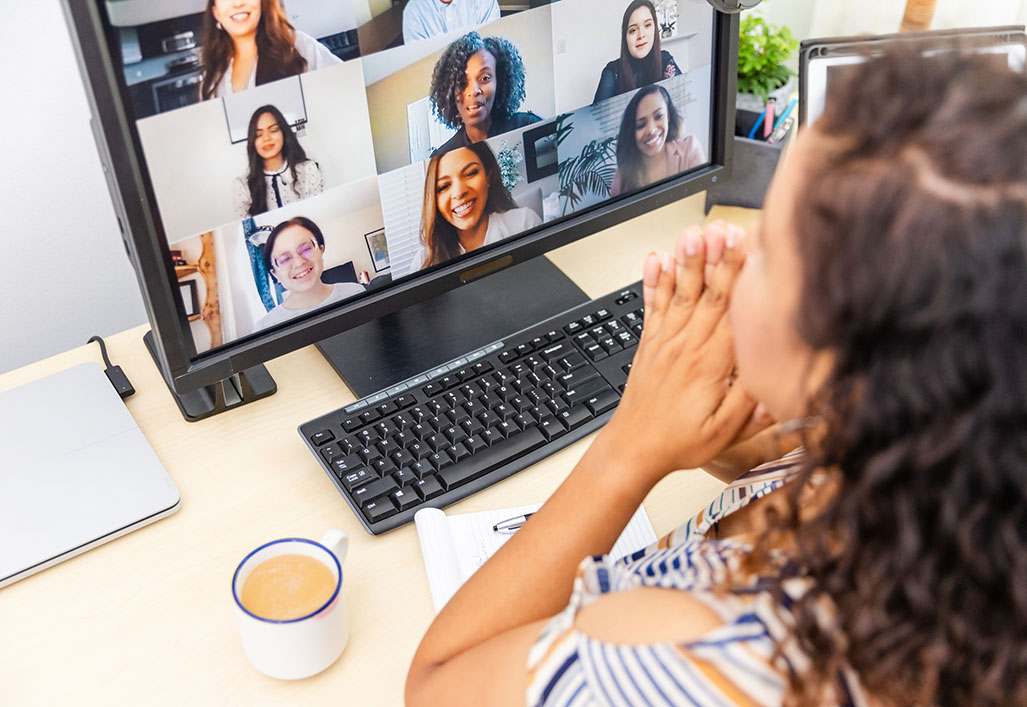 Woman participates in a video conference call with colleagues. 