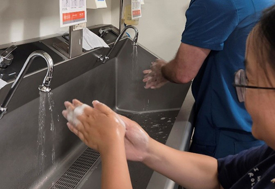 Two pediatric residents wash their hands.
