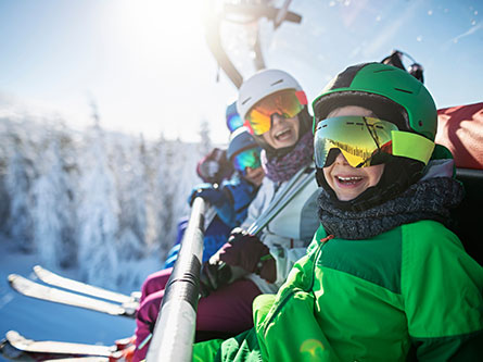 people on a ski lift with tips to avoid ski and snowboard injuries