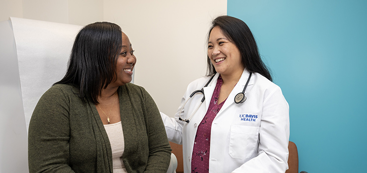 Doctor performing a routine examination on a young adult patient using a stethoscope.