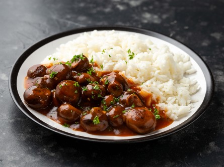 A bowl of rice and mushrooms.