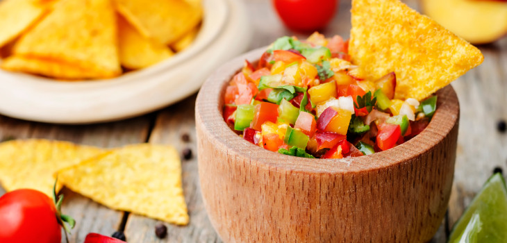 A bowl of salsa with a tortilla chip
