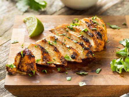 Grilled chicken slices on a cutting board