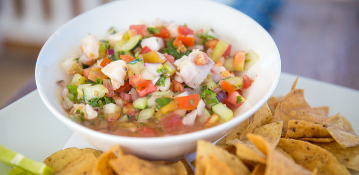 A bowl of ceviche with tortilla chips