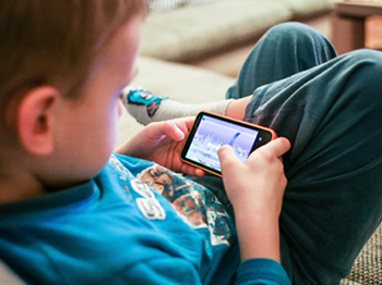 child looking at mobile phone