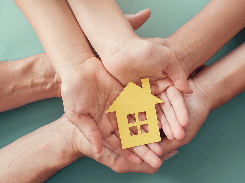 hands holding cut out home