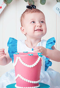 Odette with a pink cake on her birthday
