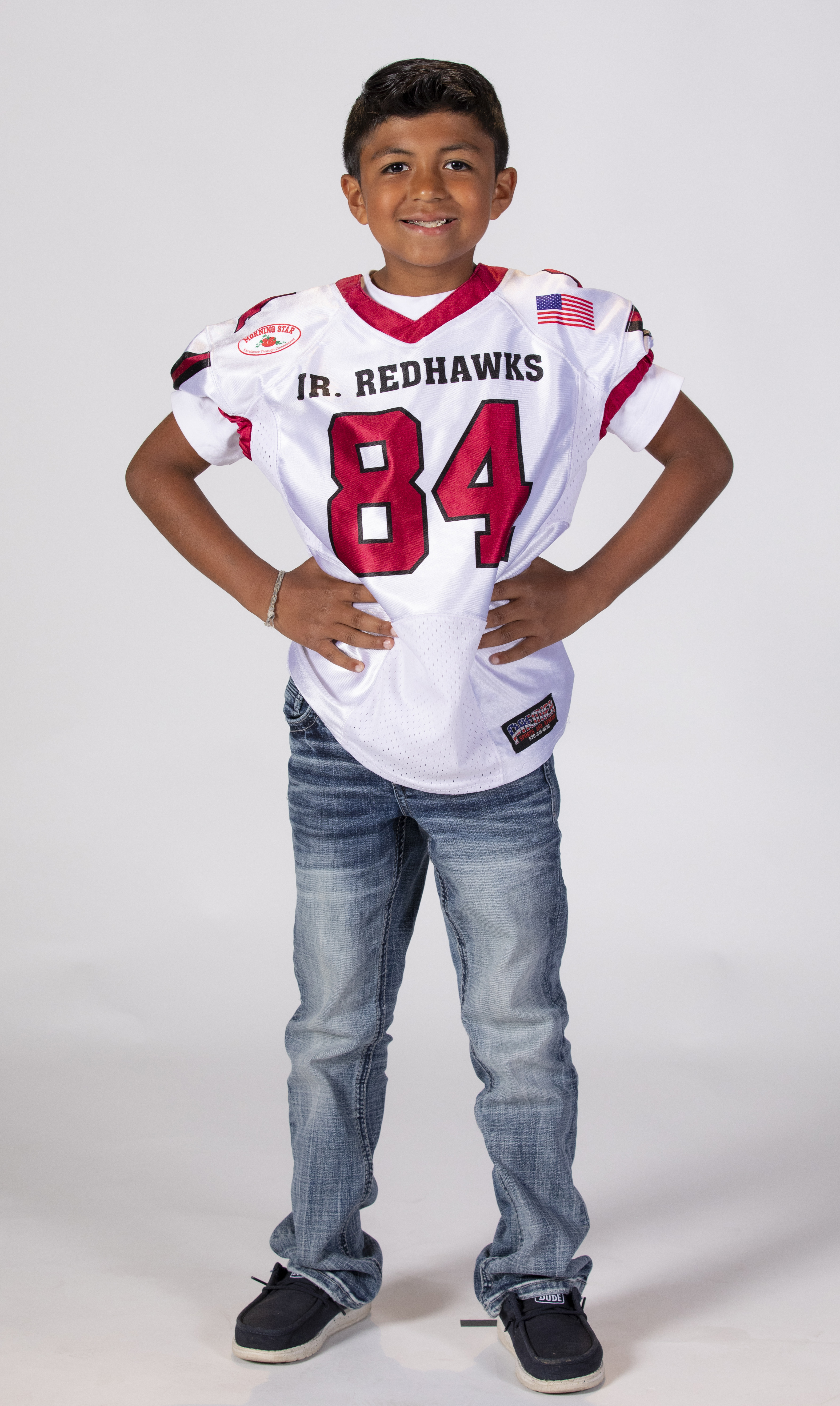 Isaac wearing his youth football jersey