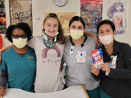 Julia in the hospital with care team members