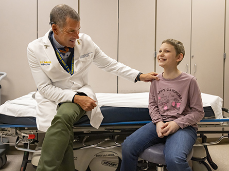 R. Lor Randall, chair of the Department of Orthopaedic Surgery, with pediatric orthopaedic patient Syndey