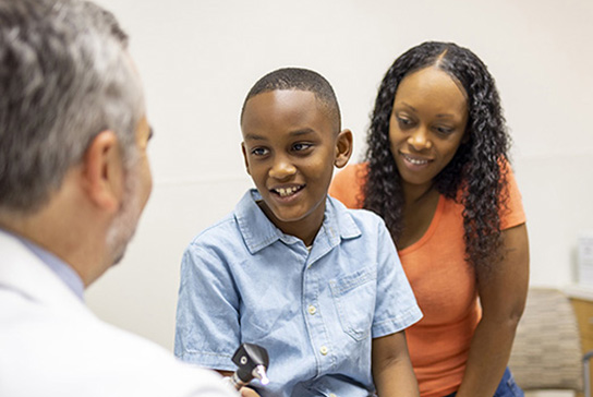 Doctor and pediatric patient with his mother