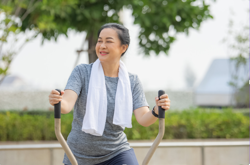 Woman smiling on exercise bike.