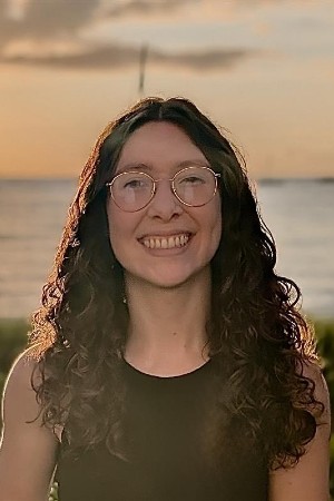 Alyssa Abreu smiling in front of a ocean view