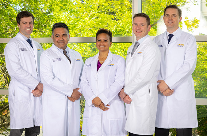UC Davis colorectal surgery team smiling and standing together.