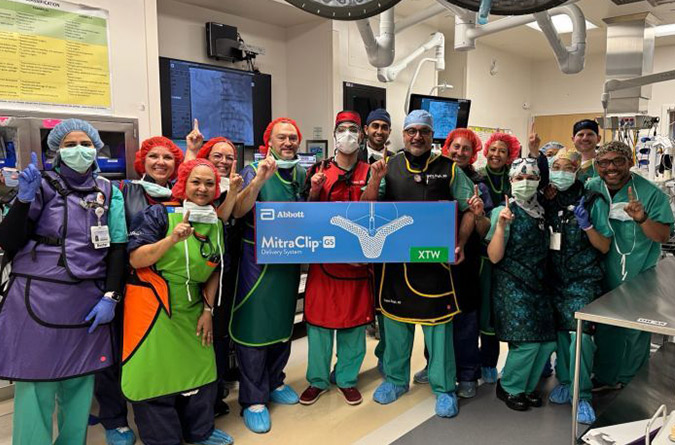 UC Davis Cardiology team members gathered together smiling after procedure completion.