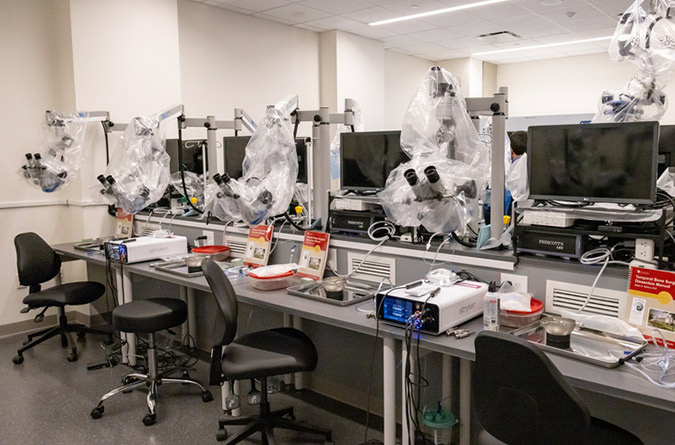 Rows of tables with research equipment in UC Davis Health's Temporal Bone Lab. 