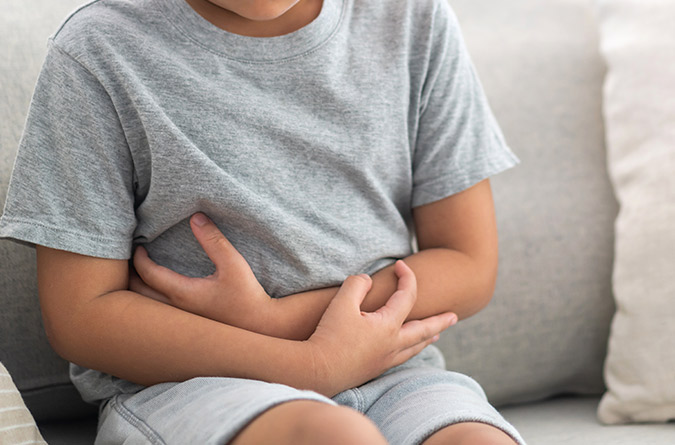 A child holding stomach.