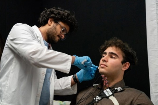 UC Davis researchers show how EMG electrodes are placed on patients.