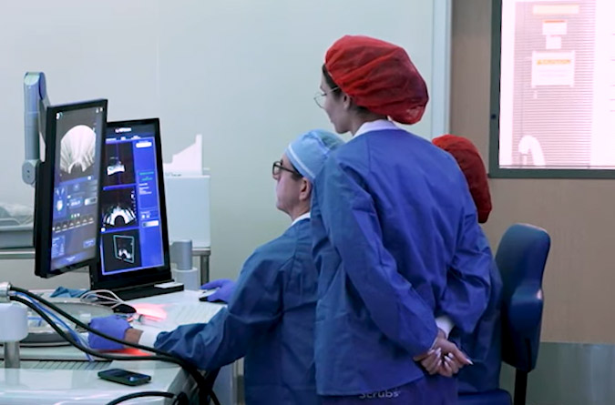 UC Davis faculty in front of computers displaying ultrasound images.