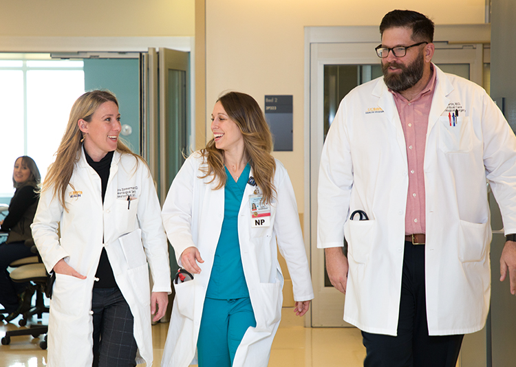 UC Davis Health healthcare providers walking inside the hospital.